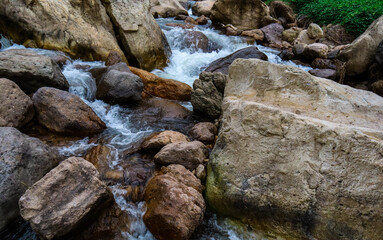 Naklejka na ściany i meble River flows over rocks in this beautiful scene