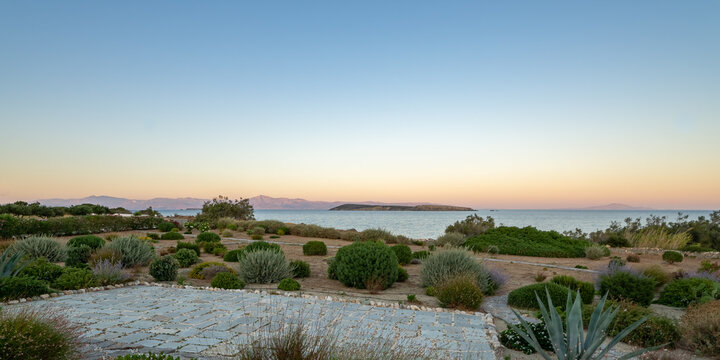 Panoramic view on Naxos island from Paros Island at sunset. Typical mediterranean vegetation. soft pastel colors. 