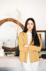 Portrait of successful beautiful woman art designer, decorator standing in studio office.
