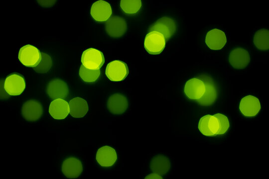 green bokeh on black background