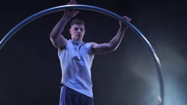 Circus artist dancing with cyr wheel. concept of concentration, willpower, and movement 