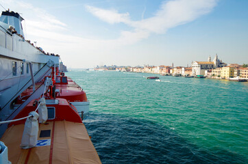 Cruiseship or cruise ship liner sailing past Venice Venezia skyline on Giudecca Canale with Piazza...