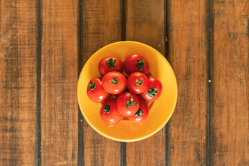 organic tomato in bowl wood background