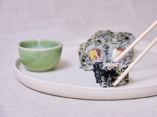 Taking Fresh sushi with chopsticks