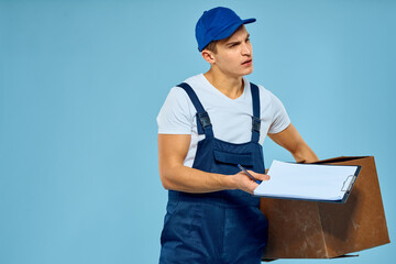 Man worker with cardboard box delivery loader lifestyle blue background