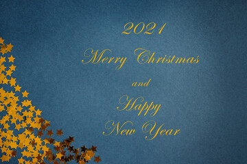 2021 numbers Merry Christmas and Happy New Year on Blue background with golden stars. texture. Copy space.