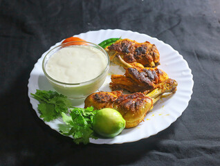 Arabian & Asian spicy food concept - homemade tandoori chicken Leg piece served with salads.