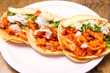 Tacos al pastor with corn tortillas. Mexican food. Mexican food concept on wooden table. Traditional Mexican food