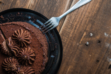 Fresh chocolate cake on wooden background