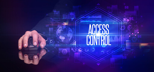 hand holding wireless peripheral with ACCESS CONTROL inscription, cyber security concept