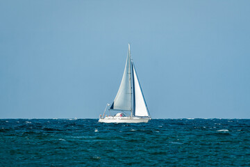 Fototapeta premium White sailing boat on the waves of the baltic sea