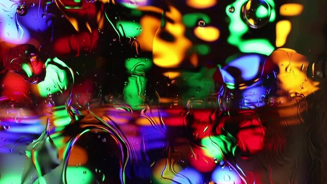 multicolored wet abstraction. backdrop with vibrant bokeh lights and oil bubbles 