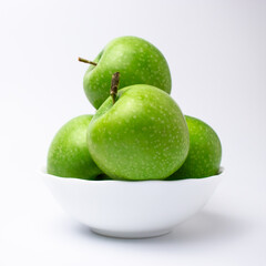 Green apples in white plate isolated.