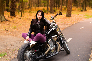Fototapeta na wymiar beautiful and happy brunette on a motorcycle