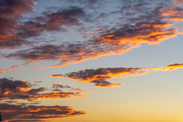 Fototapeta premium Sunset illuminating the clouds in the sky.