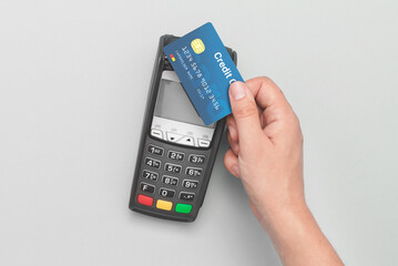 Man using credit card and payment terminal