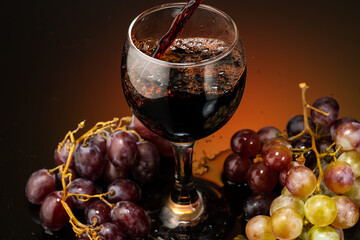 pouring red wine into a glass standing next to grapes on a gradient background