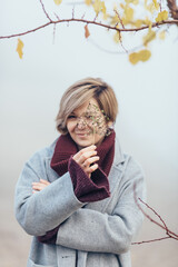 A girl runs along the shore of the lake in a foggy morning. She is having fun and has a good mood,...