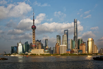 Shanghai Pudong Skyline at Yangtze in late afternoon light with transport boats