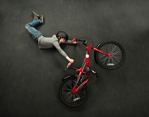 Lay flat picture of boy doing a bike trick - Powered by Adobe