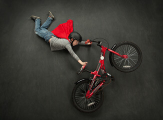 Lay flat picture of boy doing a bike trick - Powered by Adobe