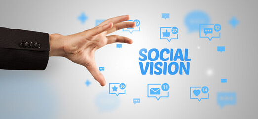Close-Up of cropped hand pointing at SOCIAL VISION inscription, social networking concept