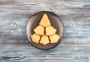 Cookies in the shape of a Christmas tree, a symbol of the New year and Christmas. Top view, the concept of festive backgrounds.