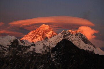 Scenic red sunset on Mount Everest Sagarmatha and Lhotse as seen from Gokyo Ri with cloud above...