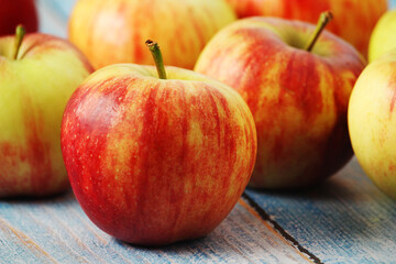 Several ripe red apples on the wooden table