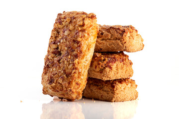 stack oatmeal cookies cinnamon with nuts isolated on white table