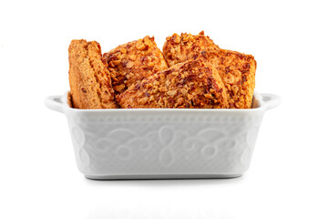 stack oatmeal cookies cinnamon with nuts isolated on white table