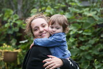 Happy Young Mother Hugs her Little 18 moth Old Baby Girl, Daughter, Happy Family Concept 