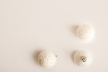 White Christmas balls on a white background close-up and copy space.