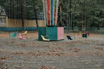 Soviet multi-colored swing in an abandoned park in Ukraine