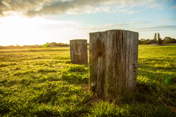 Sunrise over wooden ornamentation. Lush Grass and flowing altostratus clouds.