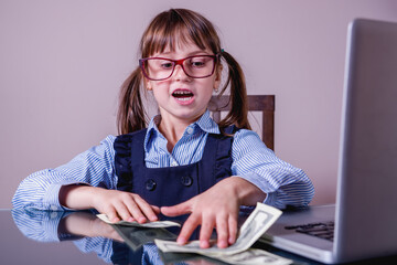 Humorous photo of young business girl calculate profit US Dollar banknotes.