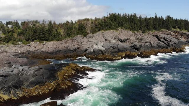 aerial view of ocean waves crashing up on the rocks on Monhegan Island Maine