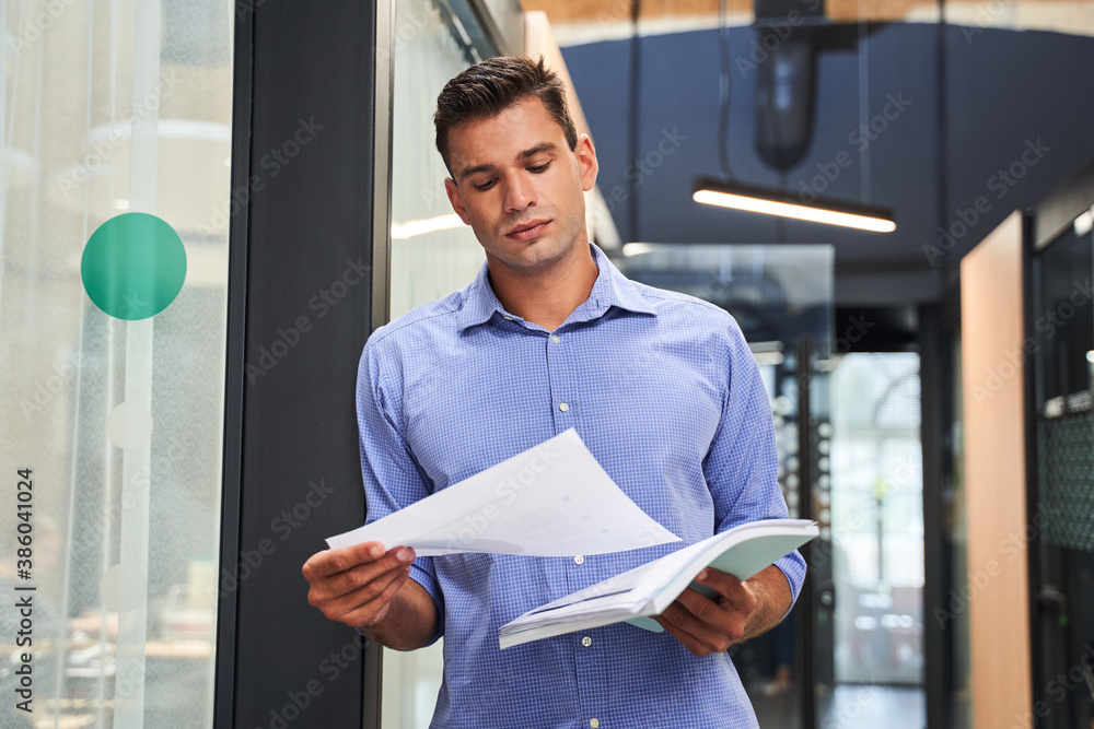 Poster man checking documents