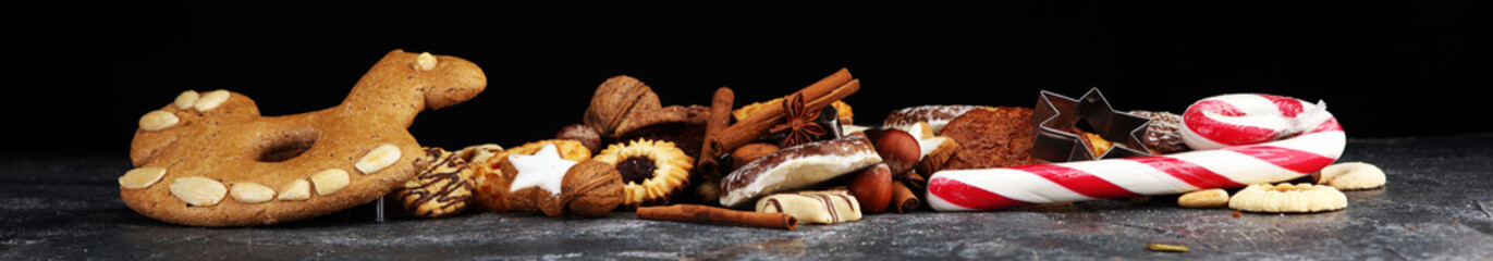 Mixed Christmas cookies. Colorful mix of Christmas-themed decorated cookies on table