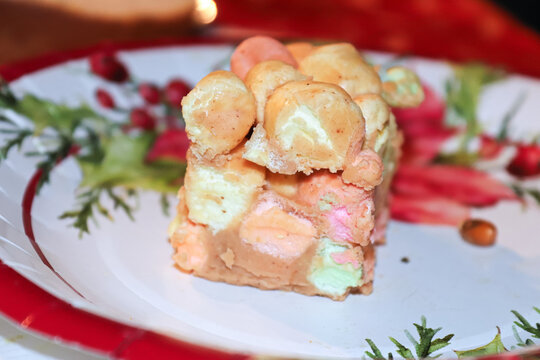 A peanut butter marshmallow square on a Christmas plate