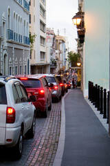 Traffic lines a narrow street at sunset in San Juan Puerto Rico