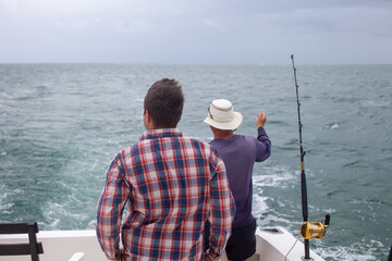 A man checks his fishing rods on a charter boat in Varadero, Cuba on a day excursion deep sea...