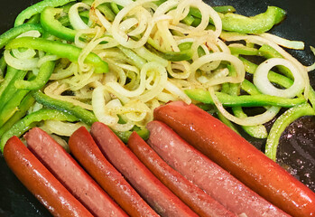 Street dogs plated with peppers and french fries