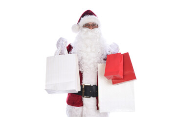 Senior man wearing a traditional Santa Claus costume holding several gift bags in both hands.  Isolated on white.