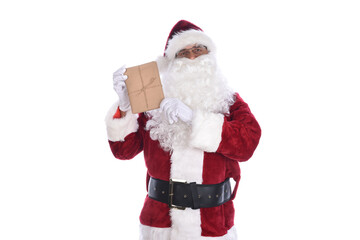 Senior man wearing a traditional Santa Claus costume holding a plain brown paper wrapped gift in his hands. Isolated on white.