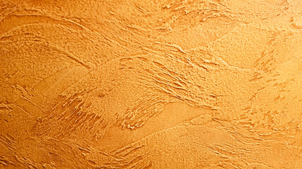 Texture of yellow decorative plaster. Abstract golden background for design with copy space for text. The surface of a beautiful cement or concrete wall texture.