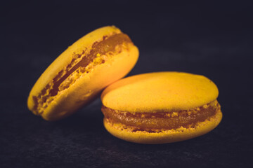 Colorful macarons on black background