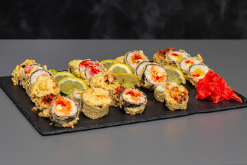 japanese sushi food. Maki ands rolls with tuna, salmon, shrimp, crab and avocado. Top view of assorted sushi. Rainbow sushi roll, uramaki, hosomaki and nigiri. Assorted sushi