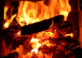 Fire and burning wood in the fireplace