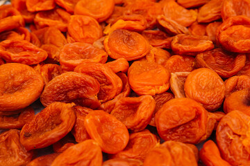 Orange dried apricots. Dried apricot, dried fruits are scattered on the table. Eco product for vegetarians